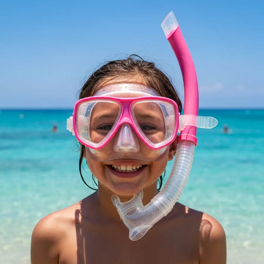 A smiling child on a sunny beach, ready to use their new kids snorkel set for underwater exploration.